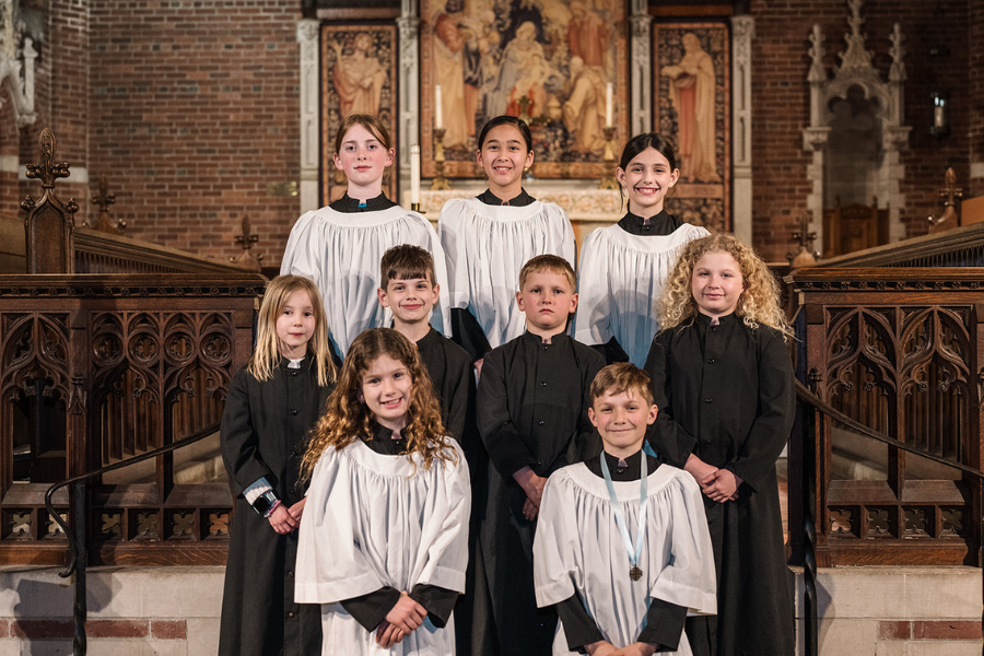 Parish of the Epiphany's Choristers, robed and standing on the sanctuary's chancel steps
