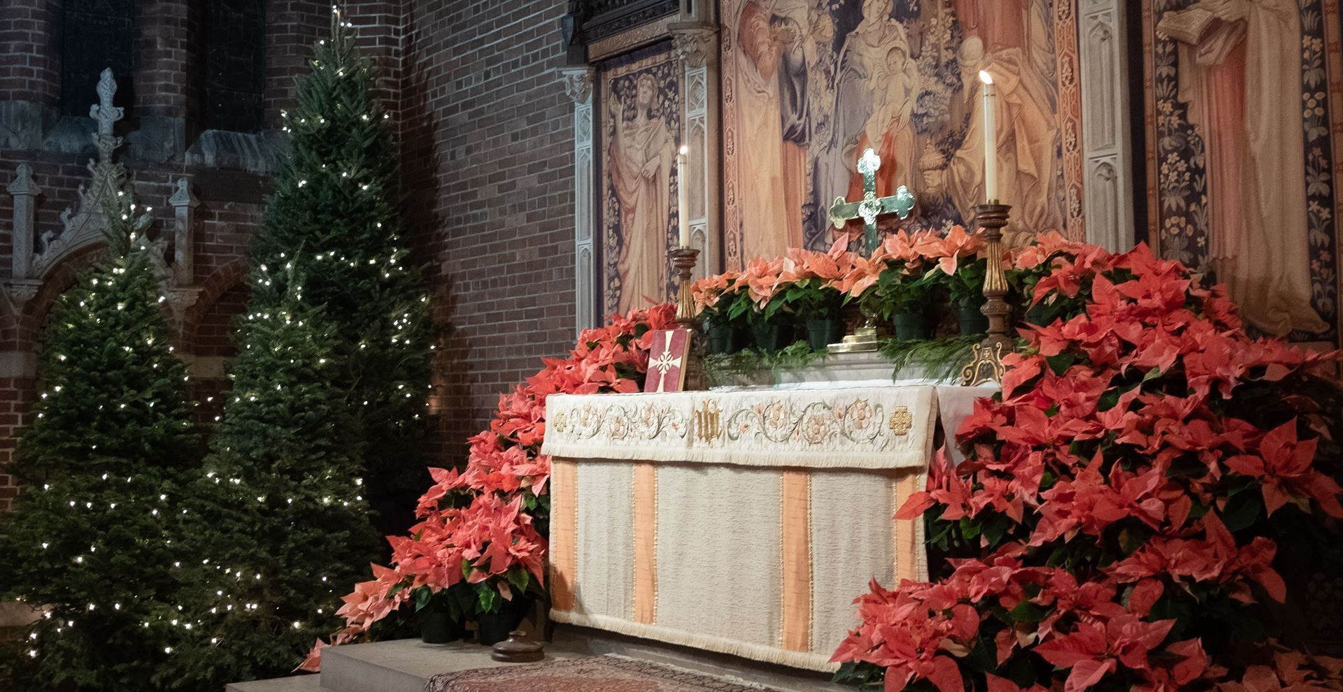Chancel of Parish of the Epiphany filled with poinsettias and Christmas greens