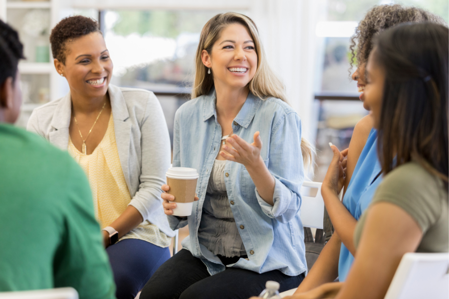 Stock image of a group of women talking in a circle